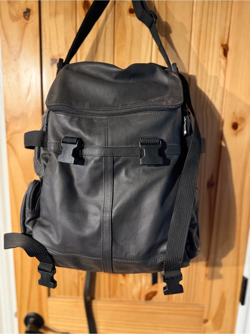 Men's Black Leather 2 piece Travel Backpack with Buckle Straps for motorcycle.